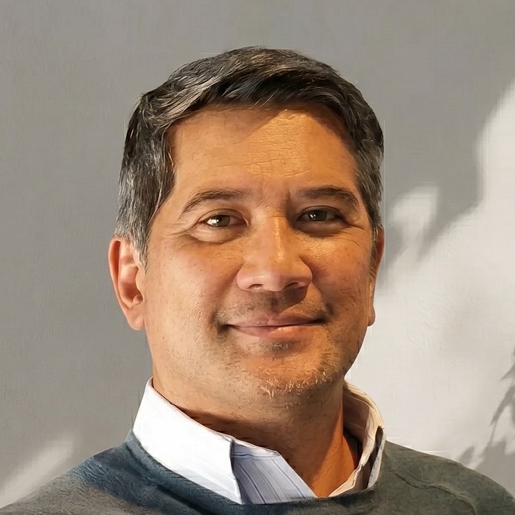 Smiling man with short hair and sweater.